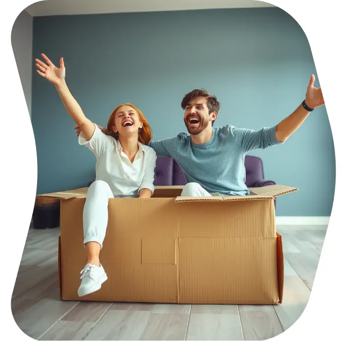 Two guys sitting on the floor of their apartment with Muval moving boxes